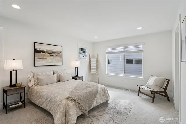 a bedroom with a bed and a painting on the wall