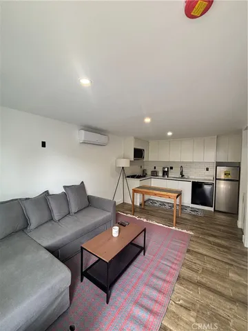 a living room with furniture and kitchen view