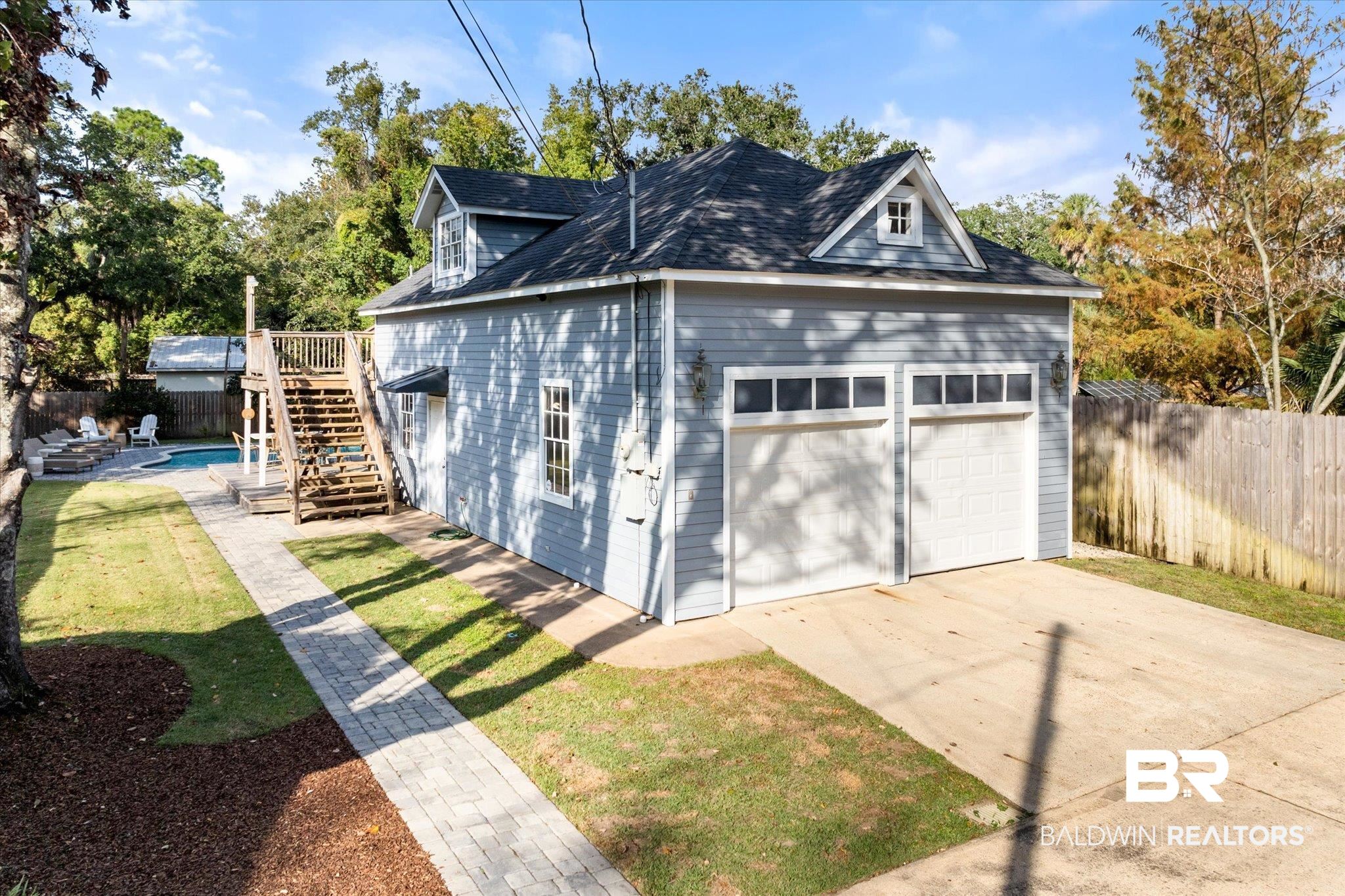 1210 Government Street Mobile, AL 36604 - Photo 28 of 37 Garage featuring a fenced in pool and a lawn