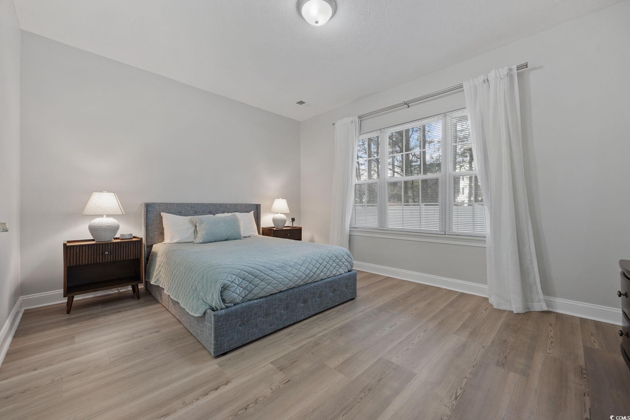 111 Fountain Pointe Lane, Unit 104 Myrtle Beach, SC 29579 - Photo 14 of 30 Bedroom featuring light wood-type flooring
