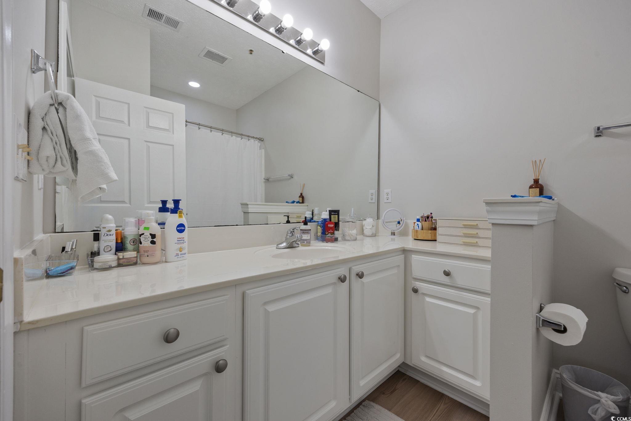 111 Fountain Pointe Lane, Unit 104 Myrtle Beach, SC 29579 - Photo 17 of 30 Full bathroom with vanity and a shower with curtain