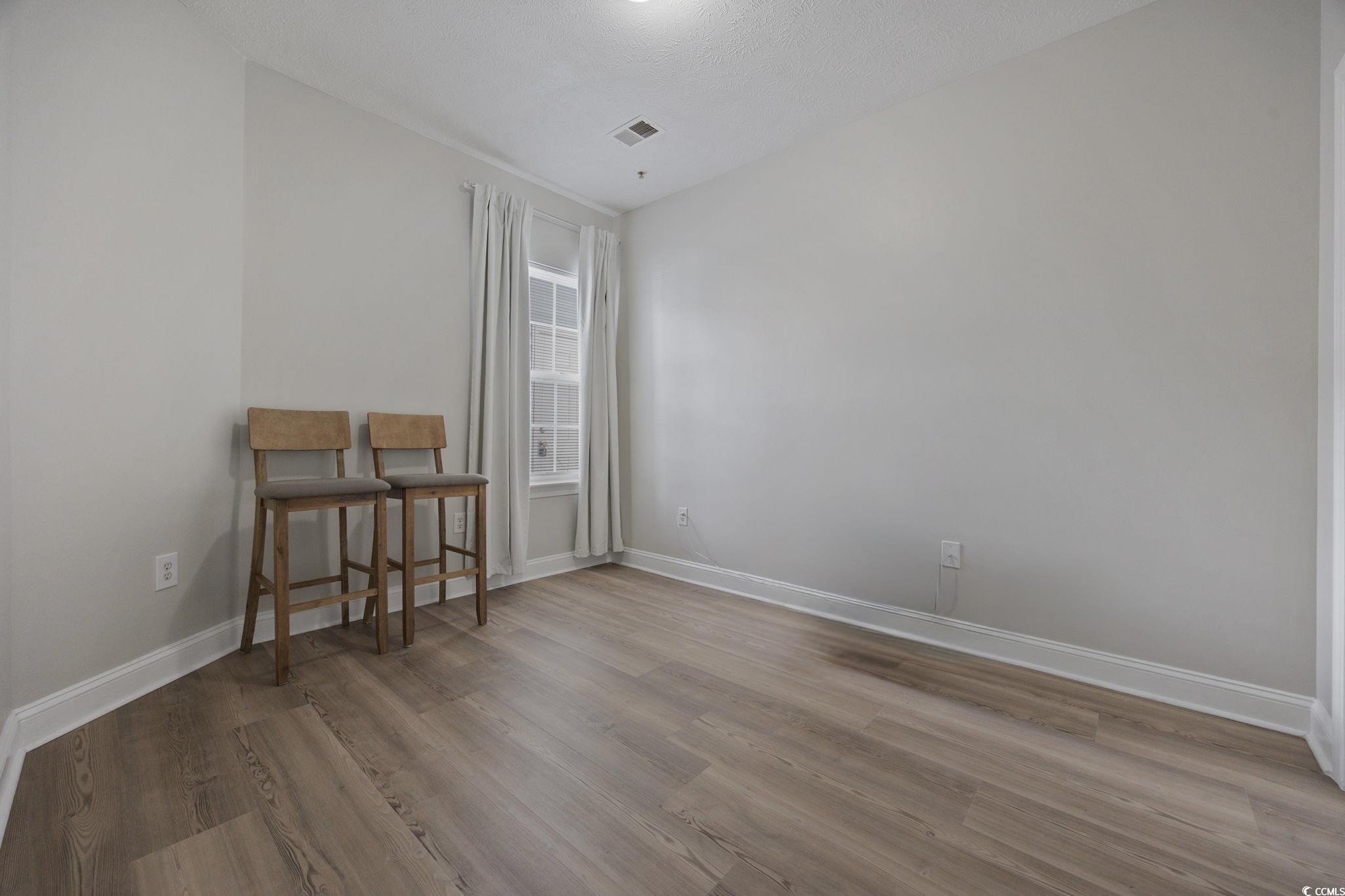 111 Fountain Pointe Lane, Unit 104 Myrtle Beach, SC 29579 - Photo 21 of 30 Unfurnished room with light wood-style flooring and baseboards