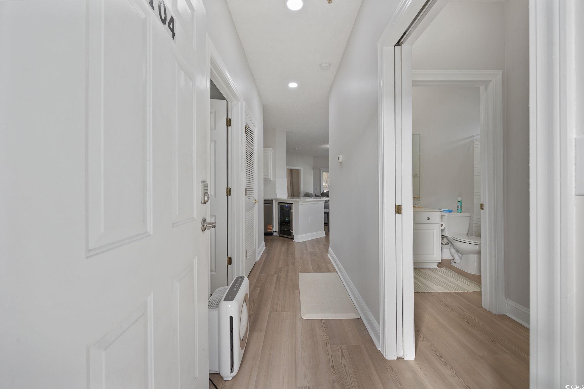 111 Fountain Pointe Lane, Unit 104 Myrtle Beach, SC 29579 - Photo 3 of 30 Hallway with recessed lighting, light wood finished floors, and wine cooler