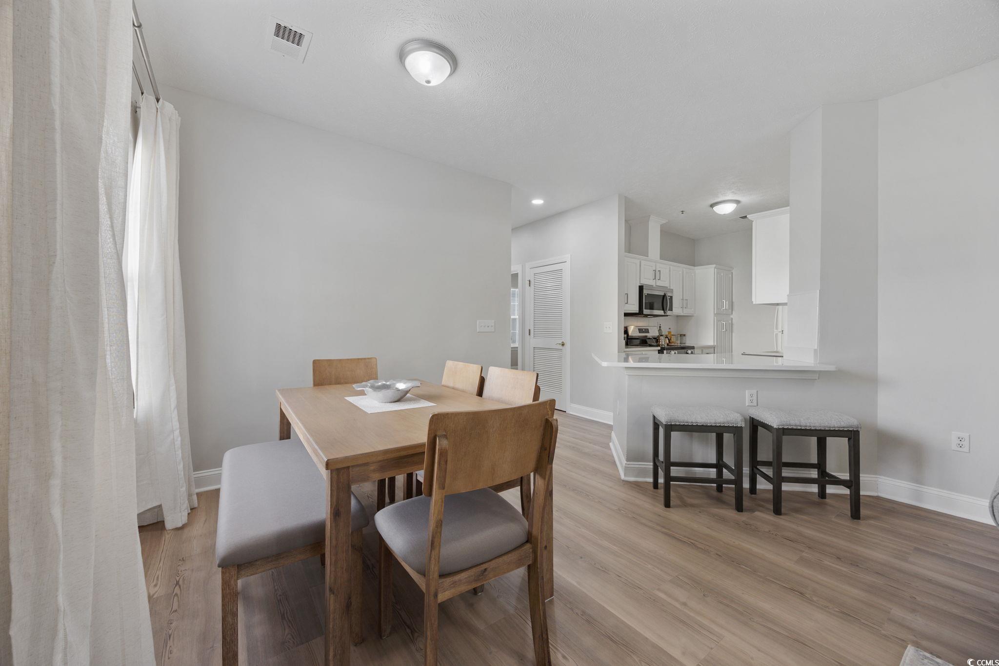 111 Fountain Pointe Lane, Unit 104 Myrtle Beach, SC 29579 - Photo 8 of 30 Dining space featuring light wood-style flooring and recessed lighting