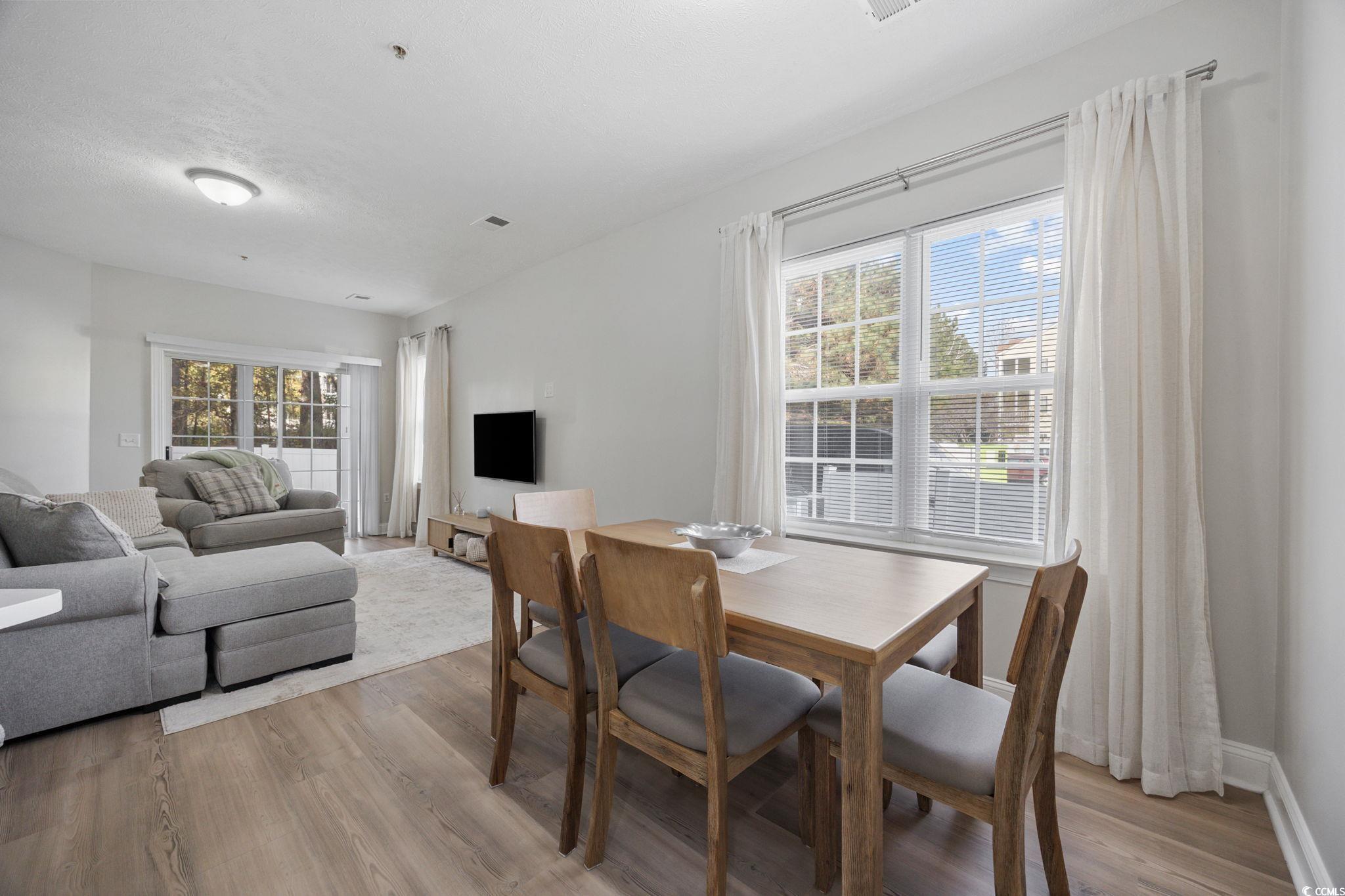 111 Fountain Pointe Lane, Unit 104 Myrtle Beach, SC 29579 - Photo 9 of 30 Dining area with light wood-style floors