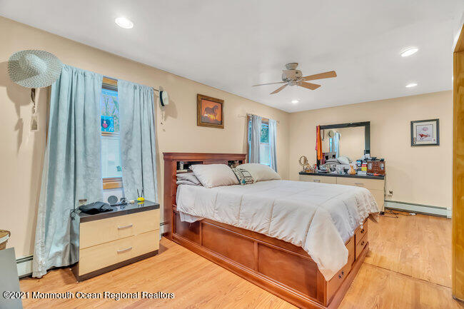 505 South Cooks Bridge Road Jackson, NJ 08527 - Photo 19 of 30 a spacious bedroom with a large bed and a chandelier