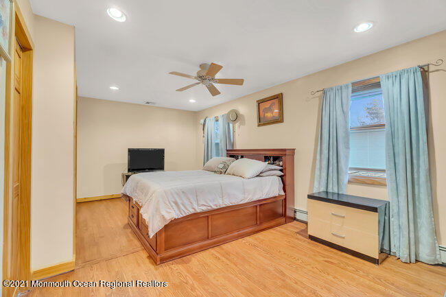 505 South Cooks Bridge Road Jackson, NJ 08527 - Photo 20 of 30 a spacious bedroom with a bed and a chandelier
