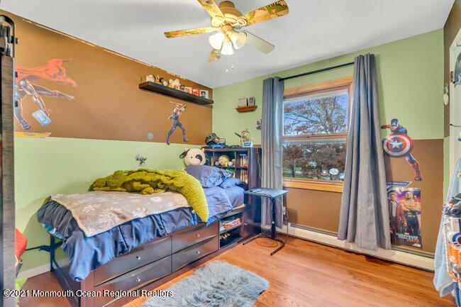 505 South Cooks Bridge Road Jackson, NJ 08527 - Photo 23 of 30 a bedroom with a bed a bookshelf and a window