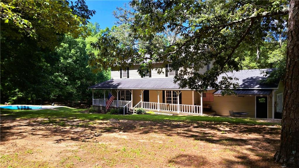 112 Brannon Road Buchanan, GA 30113 - Photo 9 of 40 a front view of a house with a garden