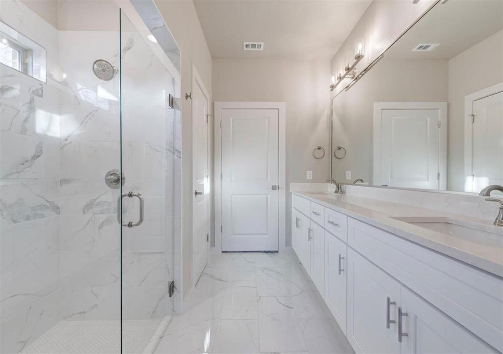 100 Hackberry Lane Roanoke, TX 76262 - Photo 7 of 10 a spacious bathroom with a granite countertop sink mirror and shower