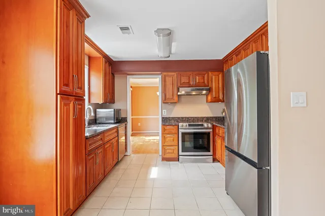 a view of empty room with wooden floor and fireplace