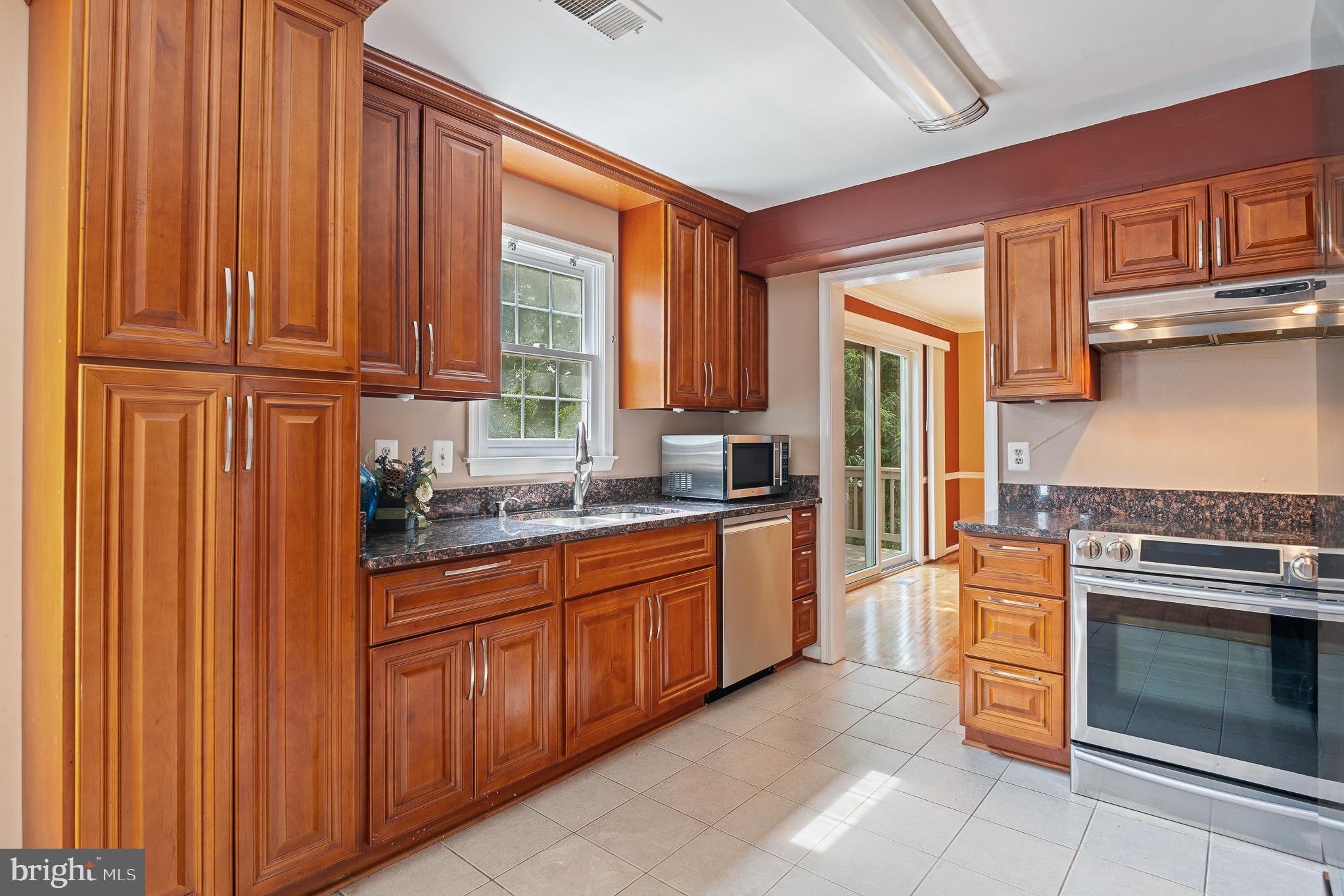 9 Coachlamp Court Silver Spring, MD 20906 - Photo 17 of 95 a kitchen with granite countertop wooden cabinets stainless steel appliances and a window
