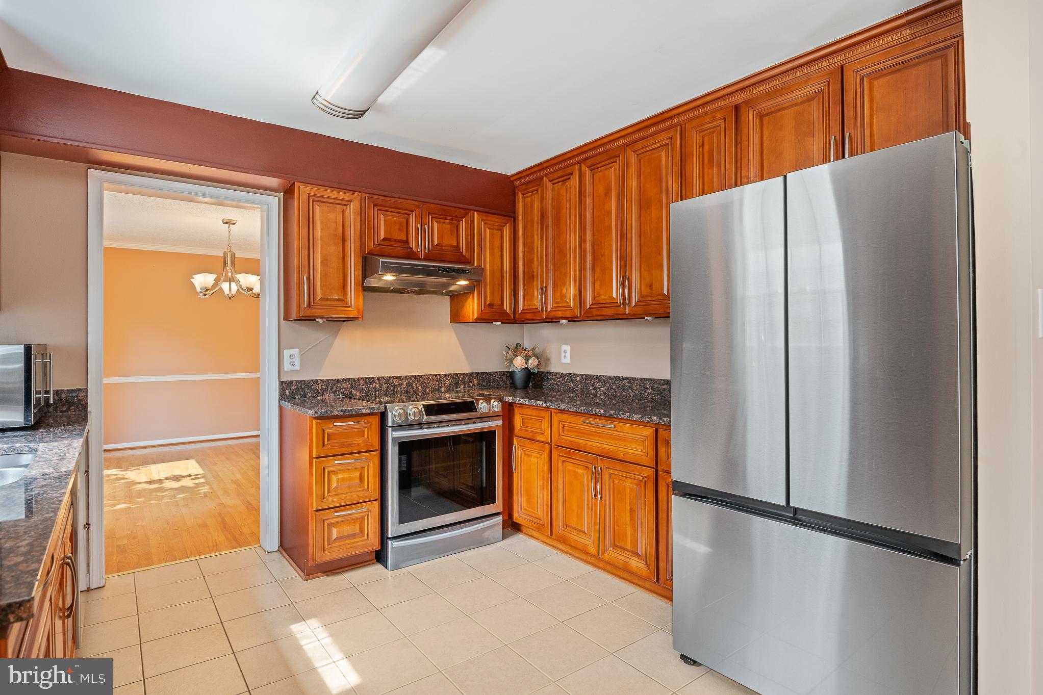 9 Coachlamp Court Silver Spring, MD 20906 - Photo 18 of 95 a kitchen with stainless steel appliances granite countertop a refrigerator stove top oven and sink