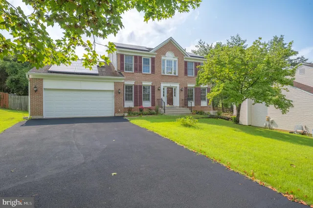 a house with swimming pool in front of it