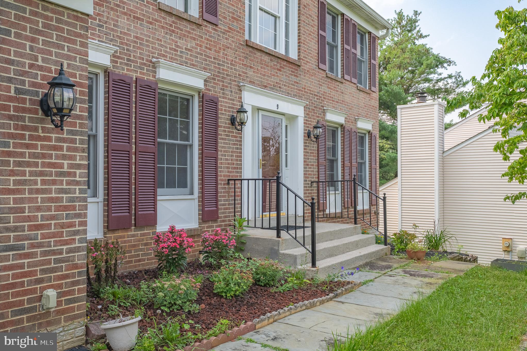 9 Coachlamp Court Silver Spring, MD 20906 - Photo 3 of 95 a view of a house with a small yard and flower plants