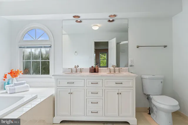 a bathroom with a sink a vanity and a mirror