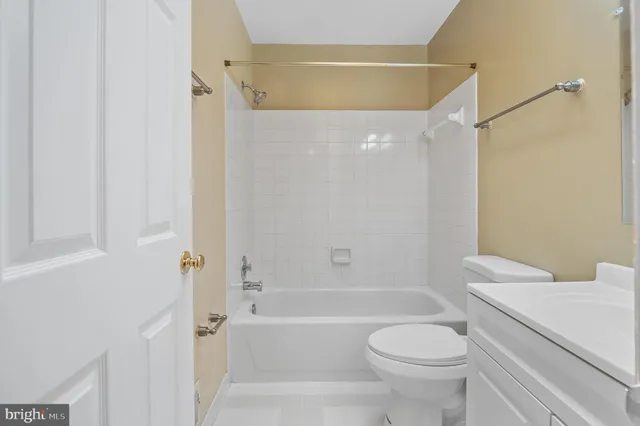 a view of a backyard with plants and large tree