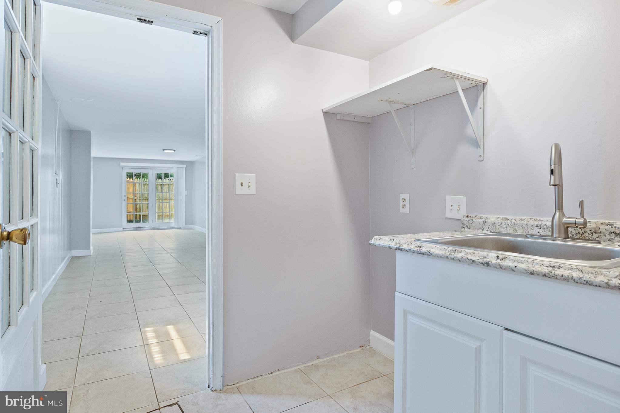 9 Coachlamp Court Silver Spring, MD 20906 - Photo 72 of 95 a bathroom with a granite countertop sink and a mirror