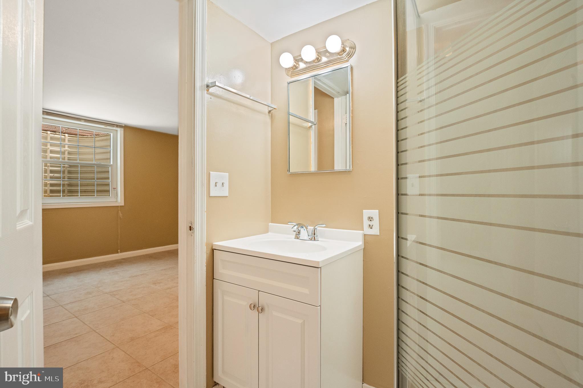 9 Coachlamp Court Silver Spring, MD 20906 - Photo 79 of 95 a bathroom with a sink a vanity and a mirror