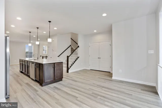 a big room with wooden floor and stairs