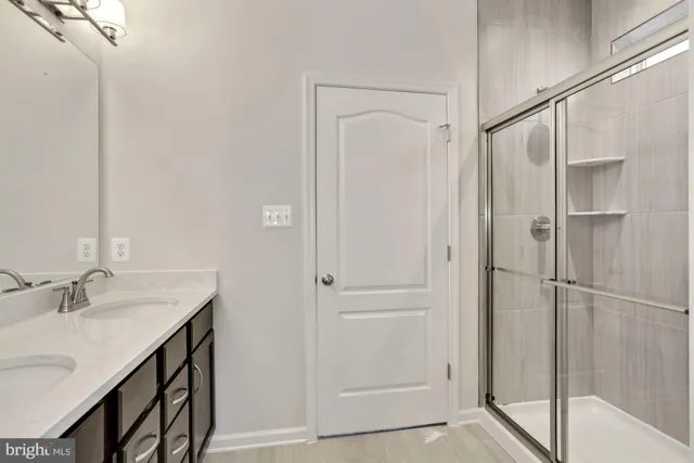 a bathroom with a shower sink and mirror