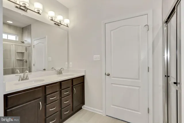 a bathroom with a double vanity sink and mirror