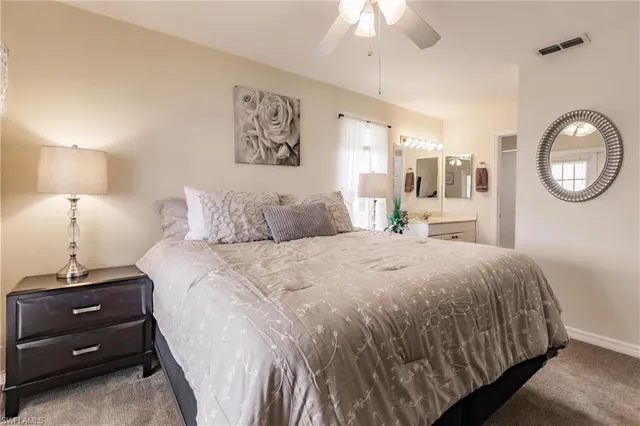 a bedroom with a bed and a lamp