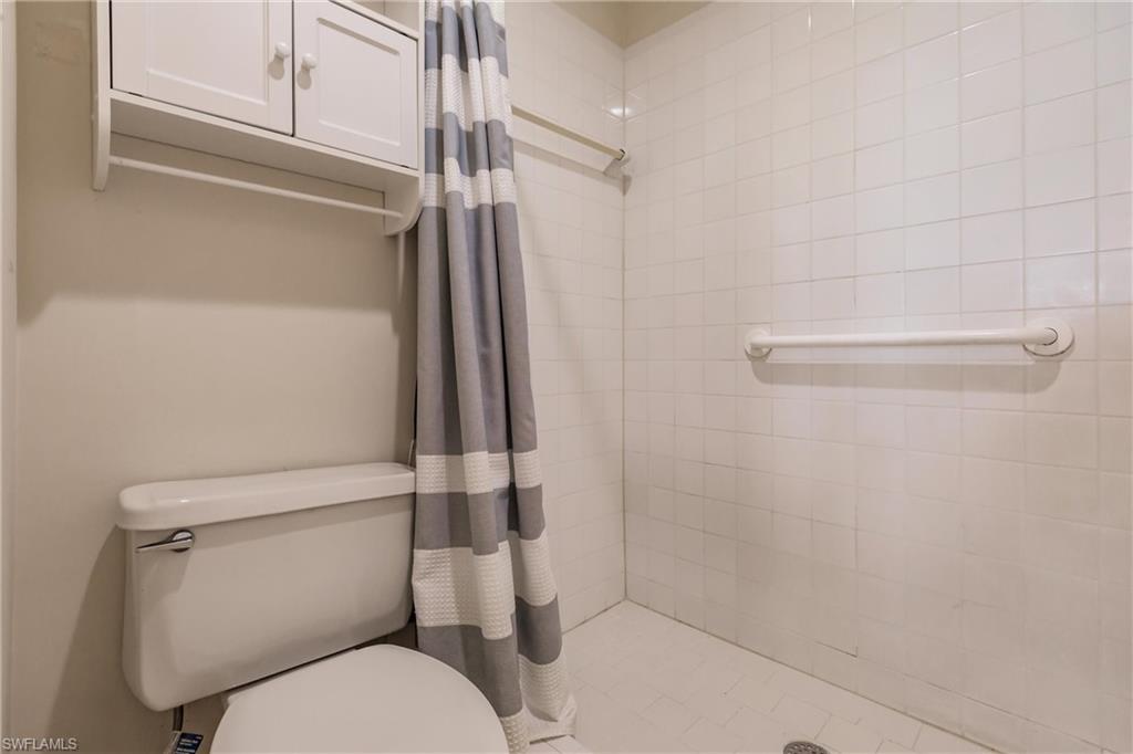 1315 Mainsail Drive, Unit 1115 Naples, FL 34114 - Photo 14 of 25 a white toilet sitting next to a shower