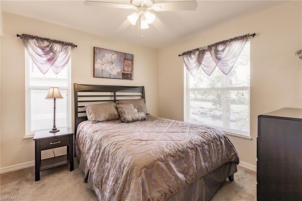 1315 Mainsail Drive, Unit 1115 Naples, FL 34114 - Photo 15 of 25 a bedroom with a bed and a window