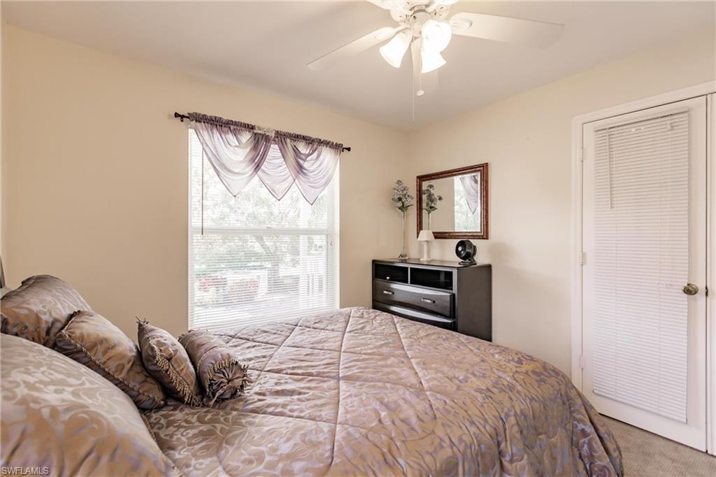1315 Mainsail Drive, Unit 1115 Naples, FL 34114 - Photo 16 of 25 a bedroom with a bed and a window