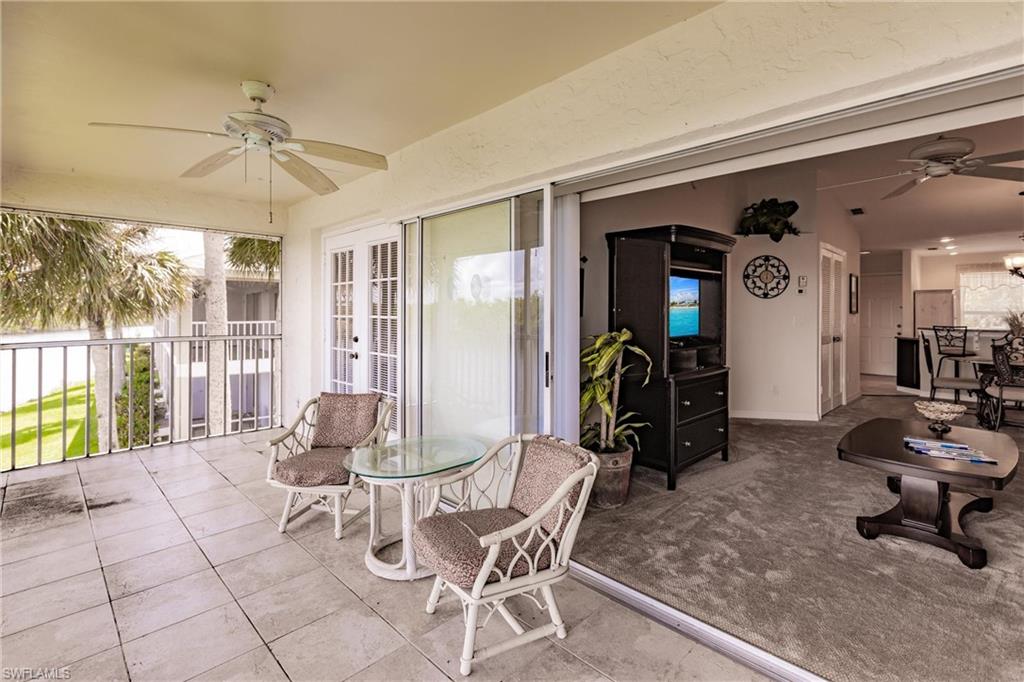 1315 Mainsail Drive, Unit 1115 Naples, FL 34114 - Photo 19 of 25 a living room with furniture a window and a chandelier