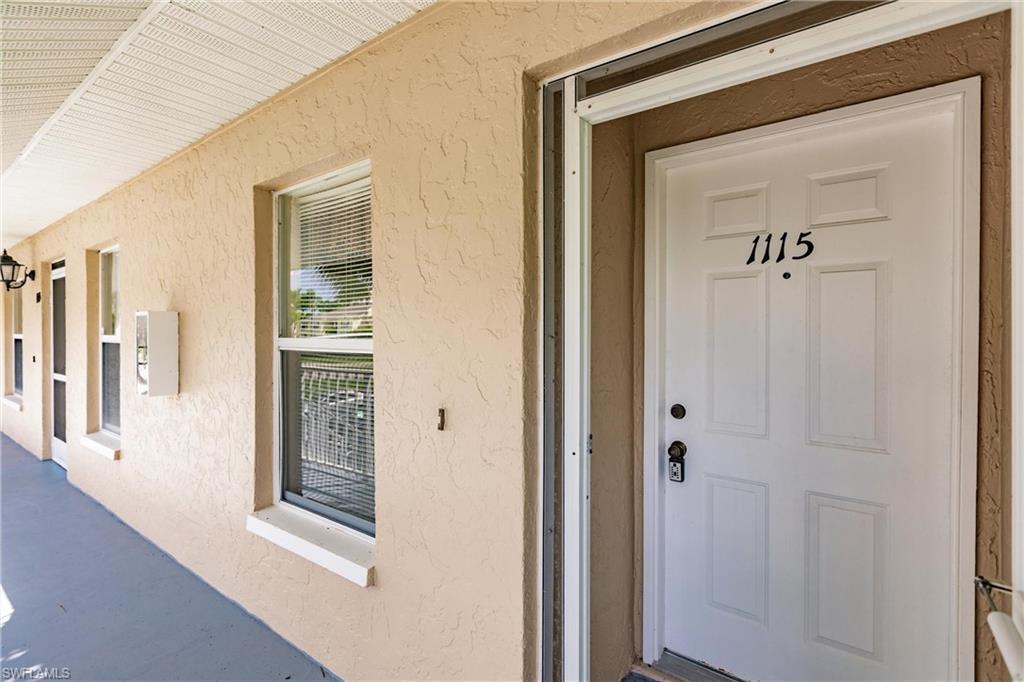1315 Mainsail Drive, Unit 1115 Naples, FL 34114 - Photo 25 of 25 a view of a hallway with wooden floor and a living room