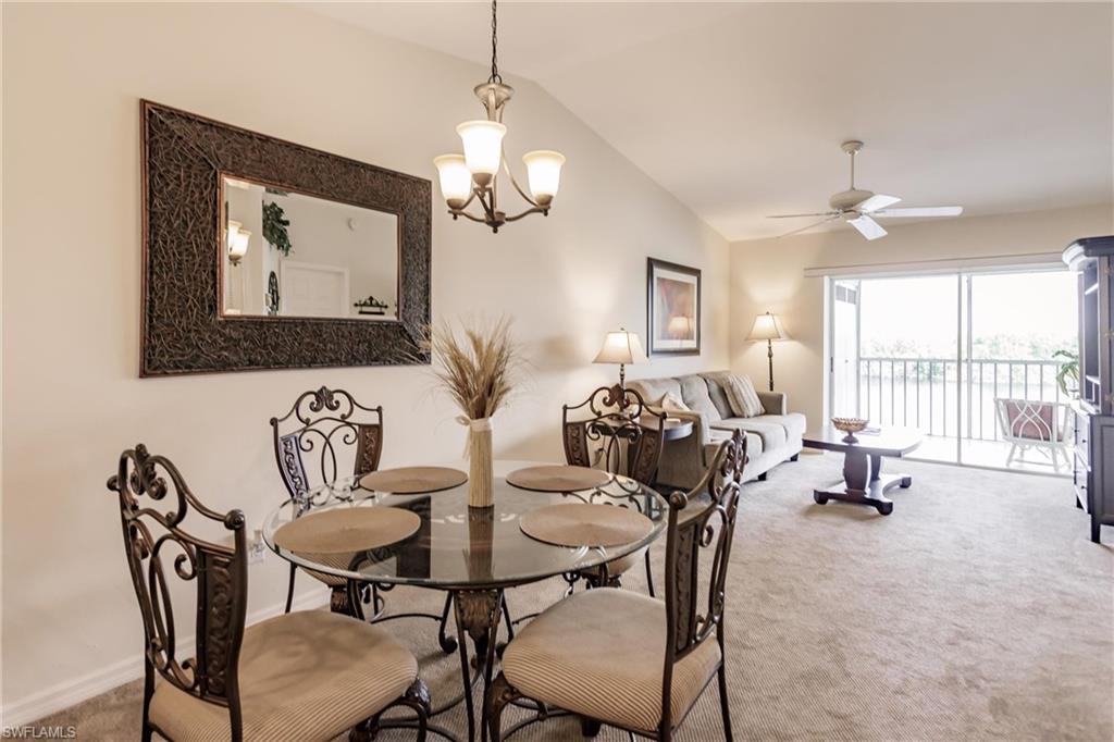 1315 Mainsail Drive, Unit 1115 Naples, FL 34114 - Photo 6 of 25 a view of a dining room with furniture and a chandelier