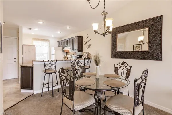 a view of a a dining room with furniture window and wooden floor