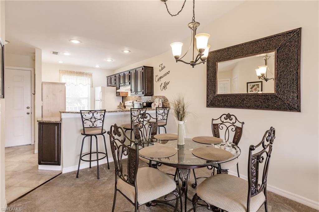 1315 Mainsail Drive, Unit 1115 Naples, FL 34114 - Photo 7 of 25 a view of a a dining room with furniture window and wooden floor
