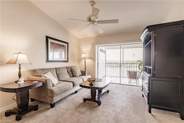 a living room with furniture a window and a table