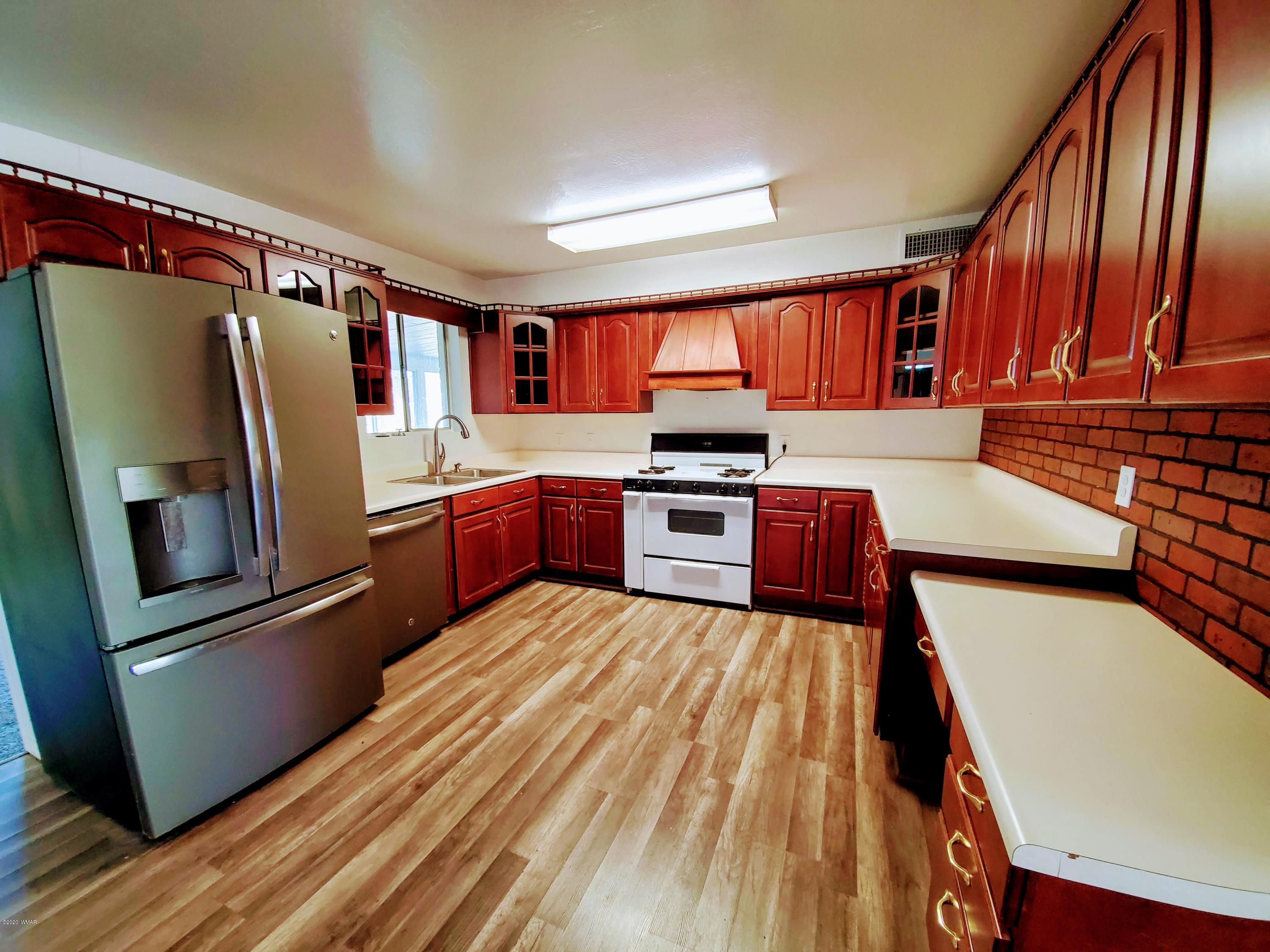 300 South 8th Street Snowflake, AZ 85937 - Photo 4 of 18 a kitchen with stainless steel appliances granite countertop a refrigerator sink and cabinets