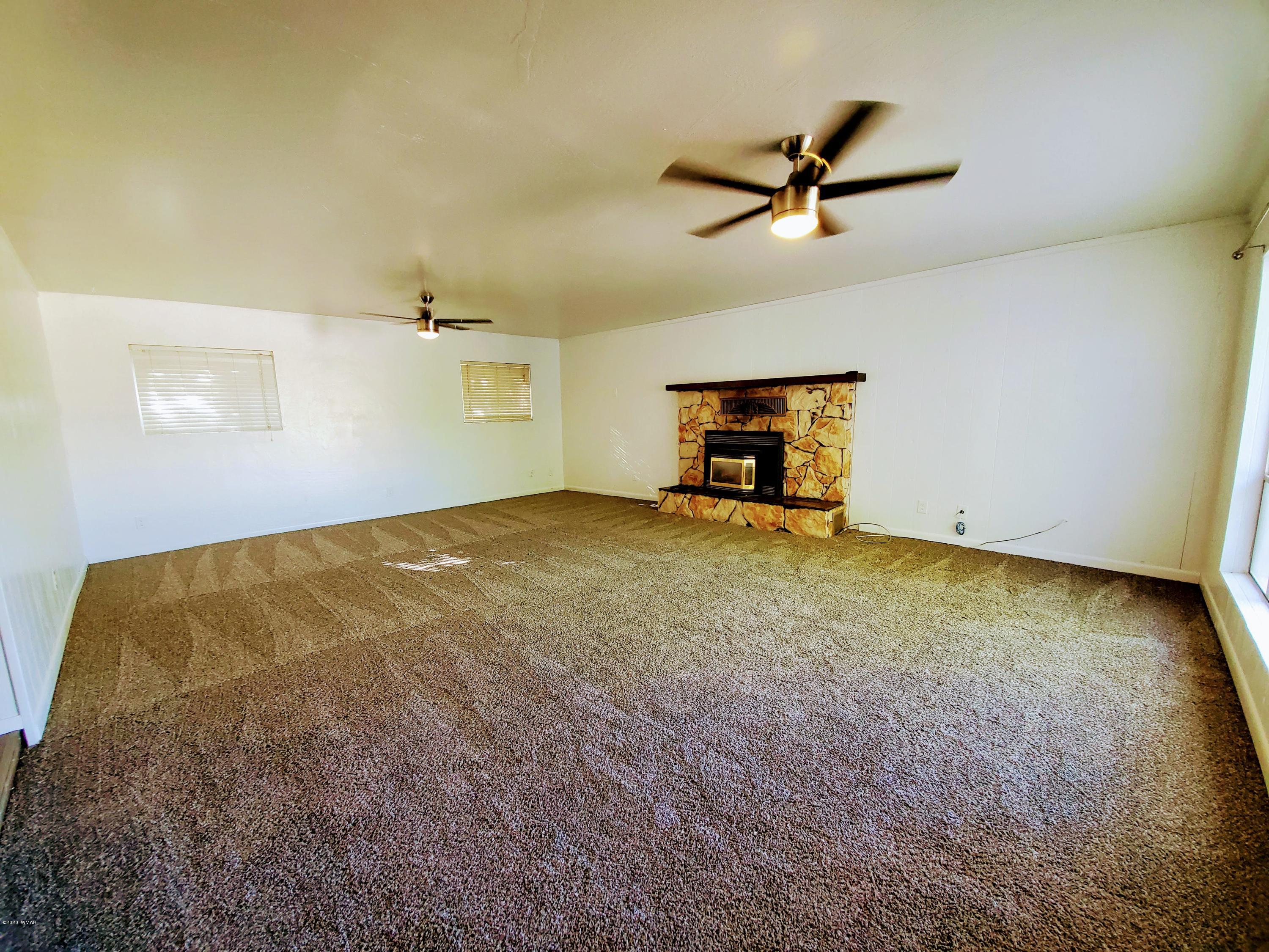 300 South 8th Street Snowflake, AZ 85937 - Photo 5 of 18 a view of a livingroom with a ceiling fan and window