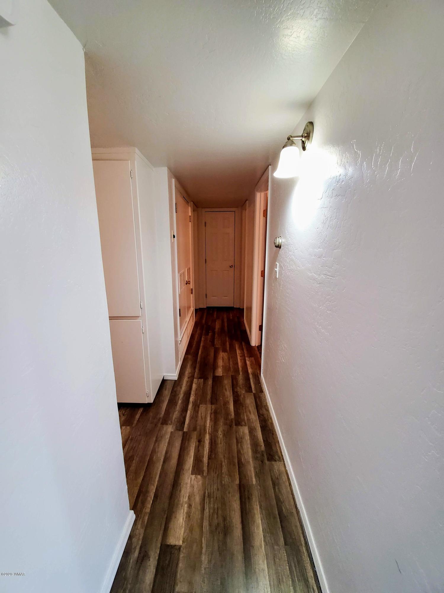 300 South 8th Street Snowflake, AZ 85937 - Photo 7 of 18 a view of a hallway with wooden floor