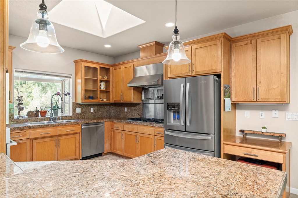 2262 Honey Run Road Chico, CA 95928 - Photo 5 of 74 a kitchen with stainless steel appliances granite countertop a refrigerator a sink dishwasher a dining table and chairs with wooden floor