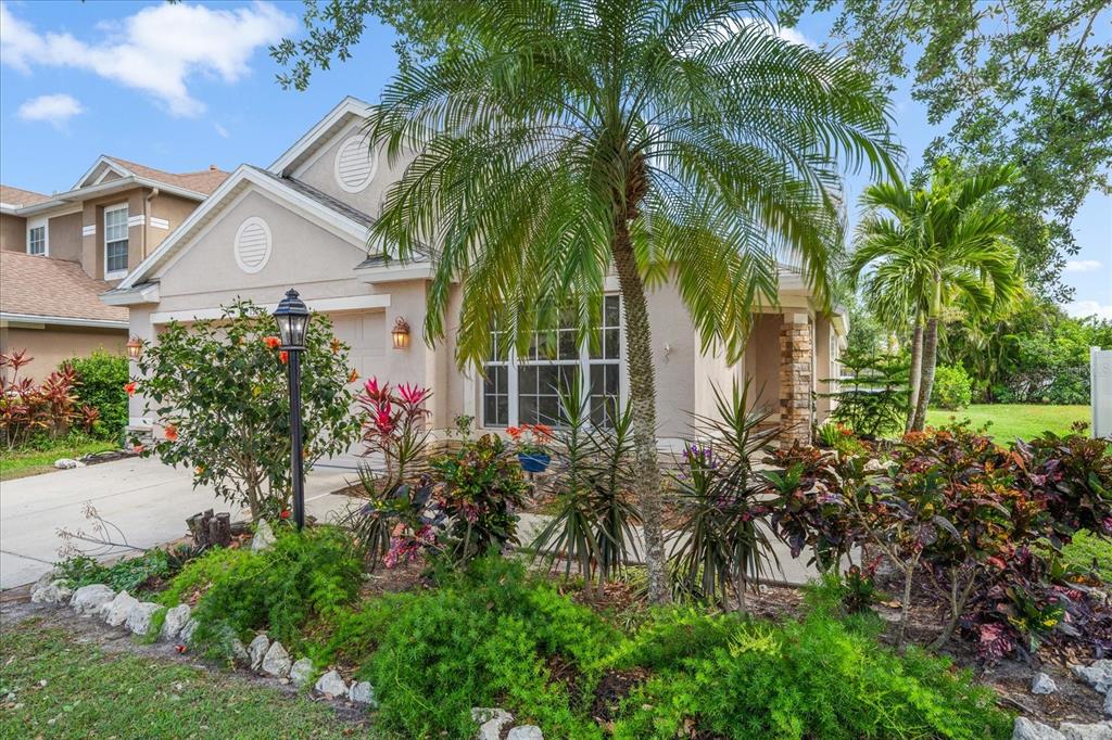 15032 Skip Jack Loop Lakewood Ranch, FL 34202 - Photo 1 of 1 a view of a white house with a yard and garden