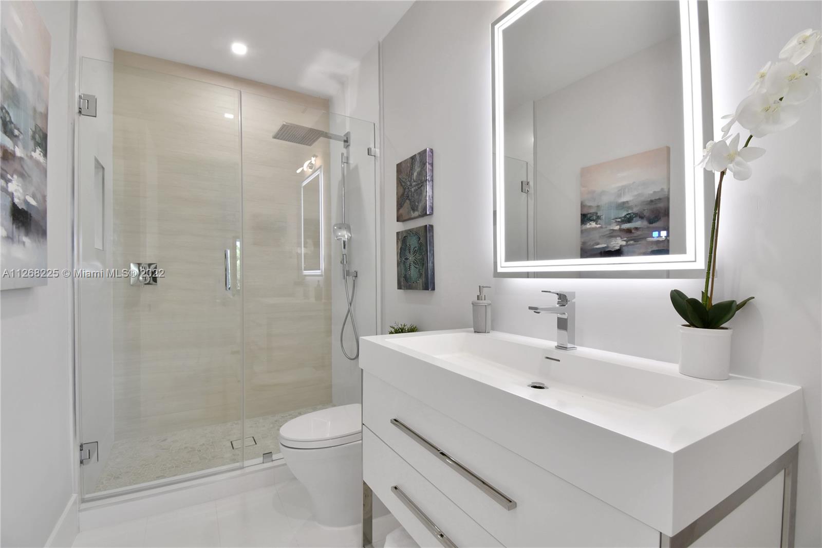 805 Northeast 70th Street Boca Raton, FL 33487 - Photo 45 of 63 a bathroom with a sink a toilet and shower