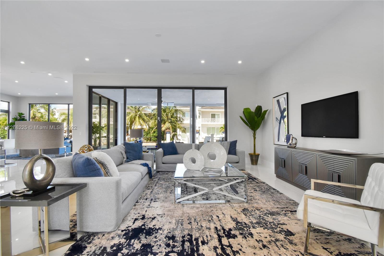 805 Northeast 70th Street Boca Raton, FL 33487 - Photo 53 of 63 a living room with furniture and a flat screen tv