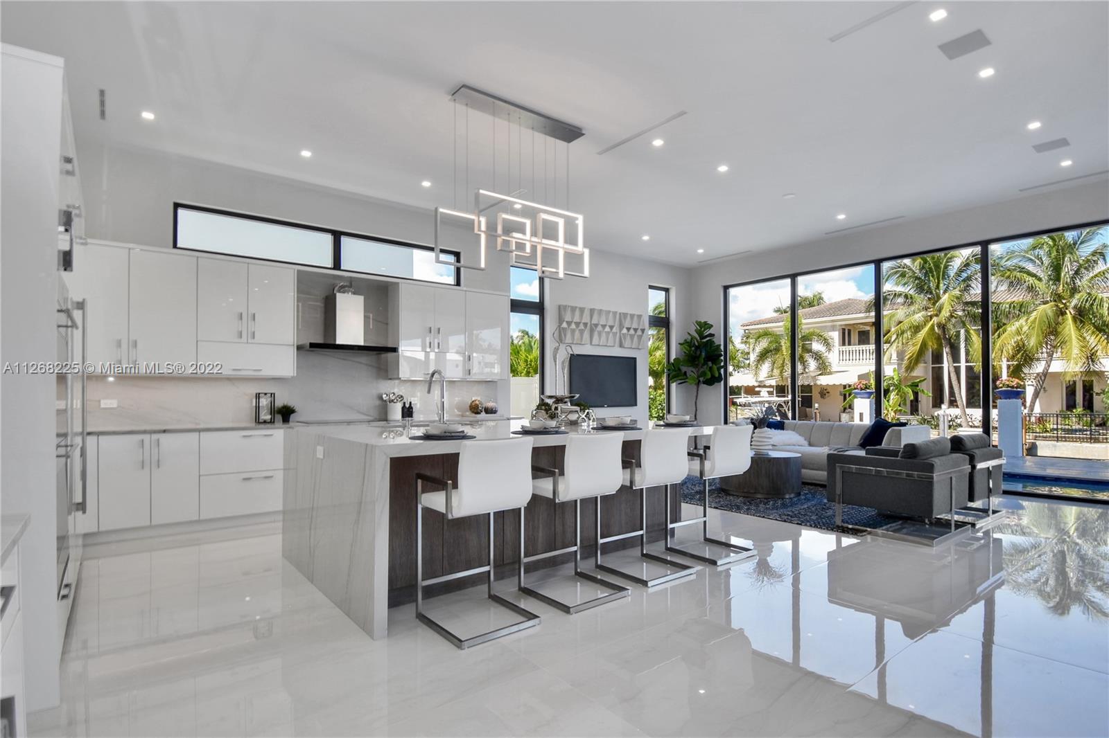 805 Northeast 70th Street Boca Raton, FL 33487 - Photo 54 of 63 a living room with kitchen island furniture and a large window