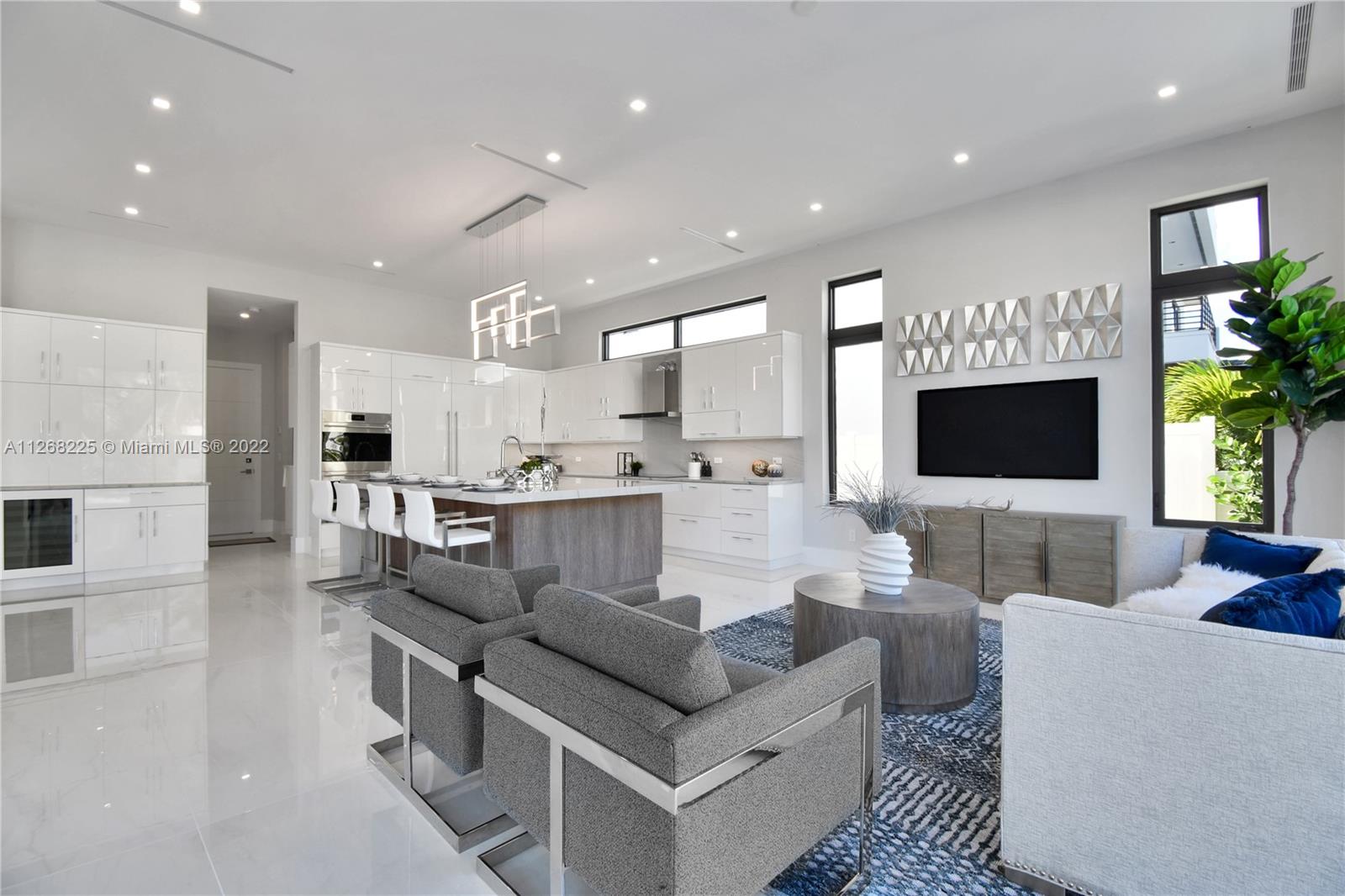 805 Northeast 70th Street Boca Raton, FL 33487 - Photo 58 of 63 a living room with furniture and a flat screen tv