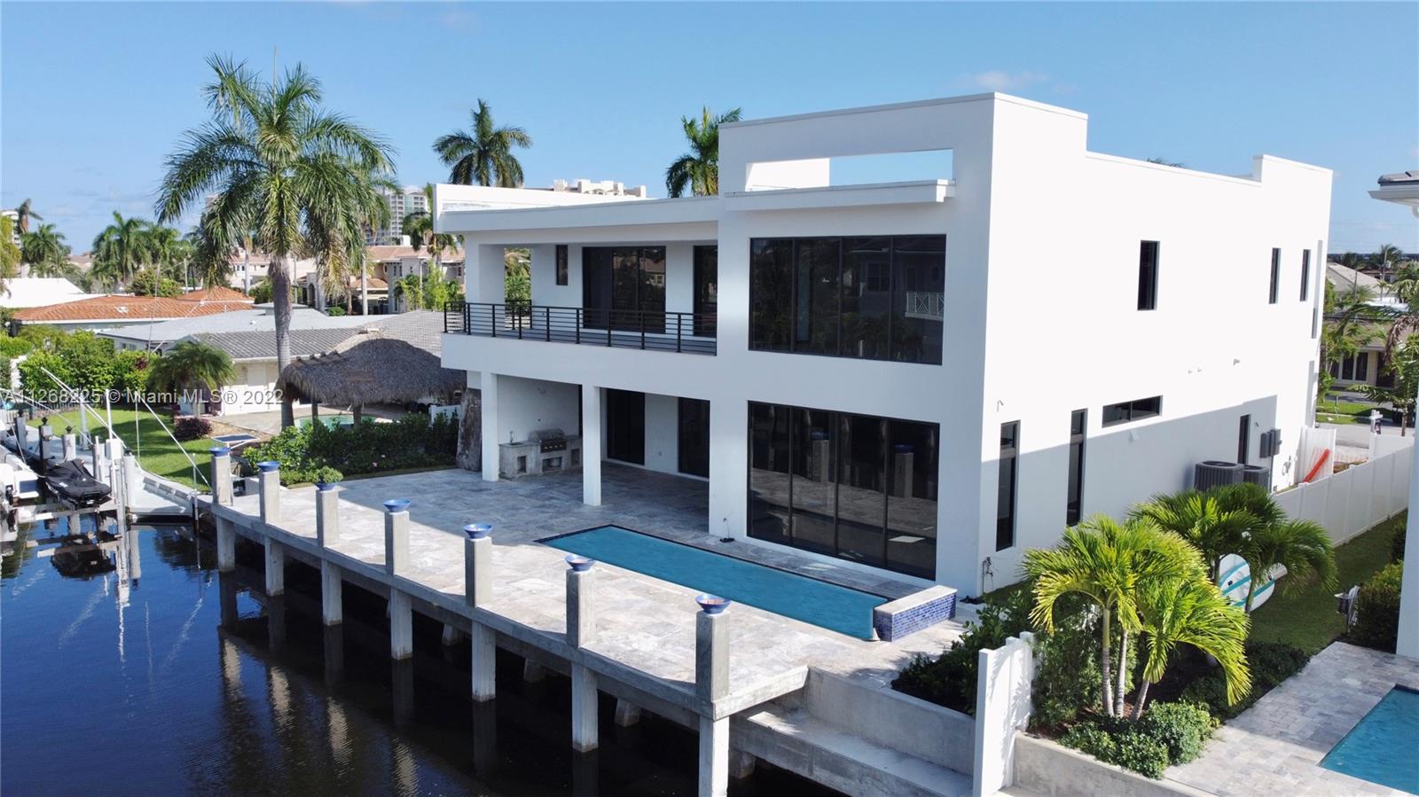 805 Northeast 70th Street Boca Raton, FL 33487 - Photo 63 of 63 a view of a house with backyard and porch