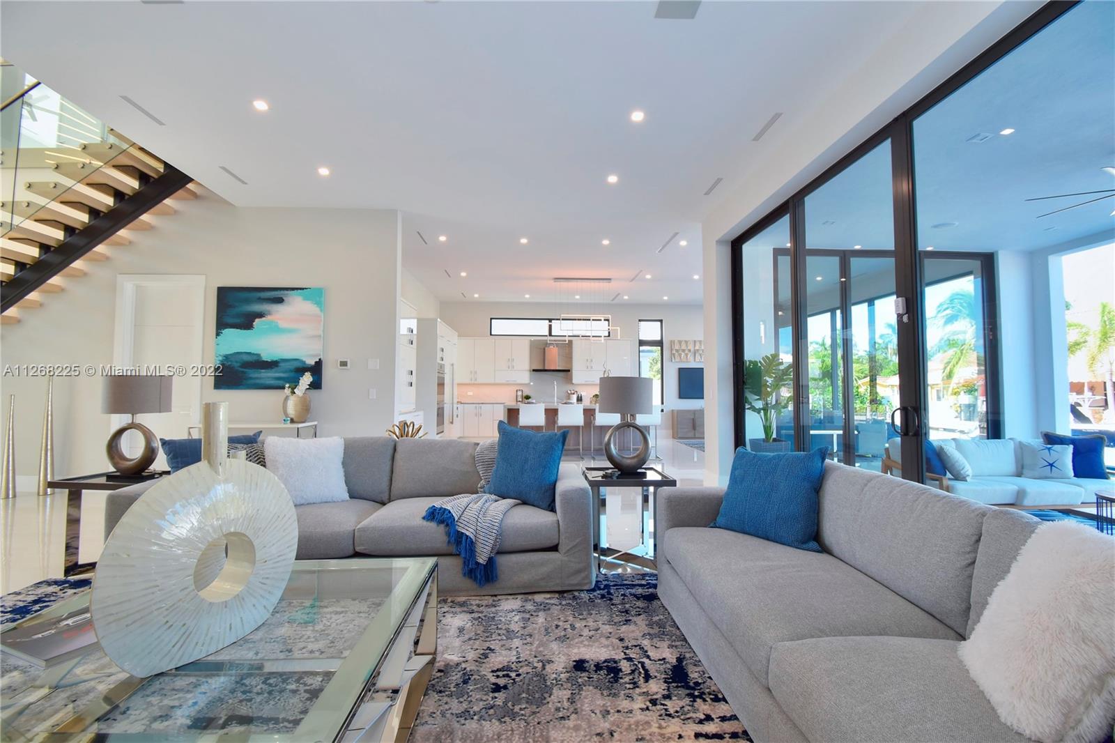 805 Northeast 70th Street Boca Raton, FL 33487 - Photo 7 of 63 a living room with furniture wooden floor and a large window