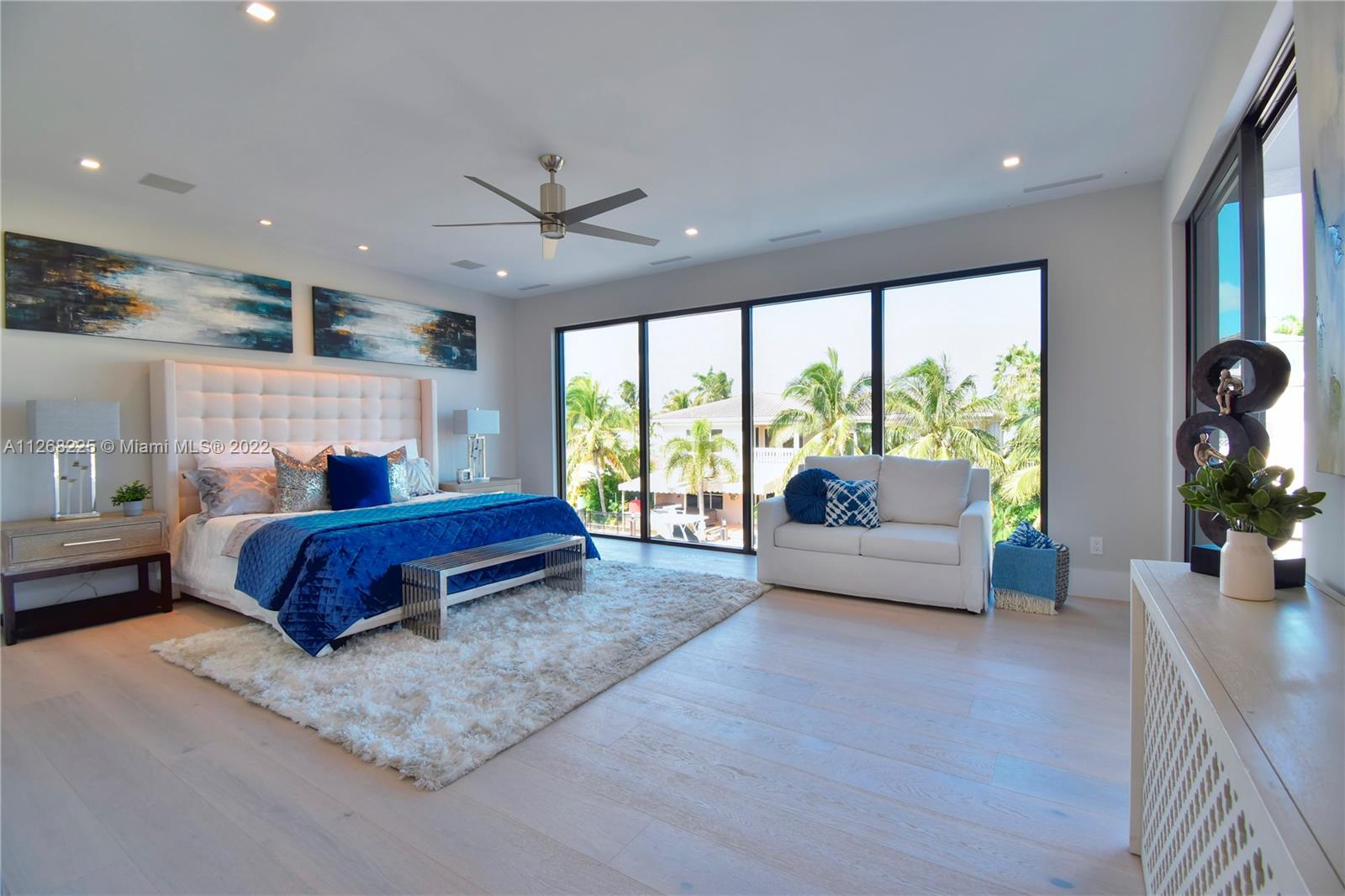 805 Northeast 70th Street Boca Raton, FL 33487 - Photo 9 of 63 a spacious bedroom with a bed and a couch