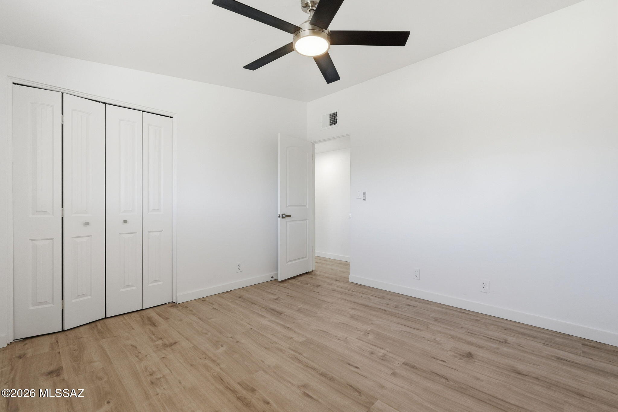 950 West Ina Road Tucson, AZ 85704 - Photo 27 of 54 a view of an empty room with wooden floor