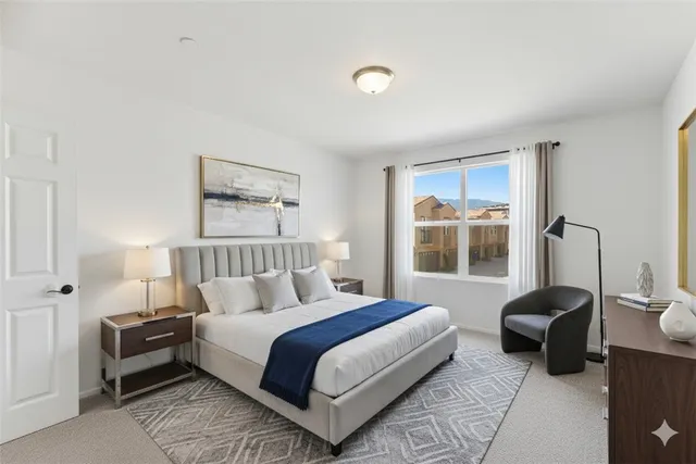 a bedroom with a bed a table and a window